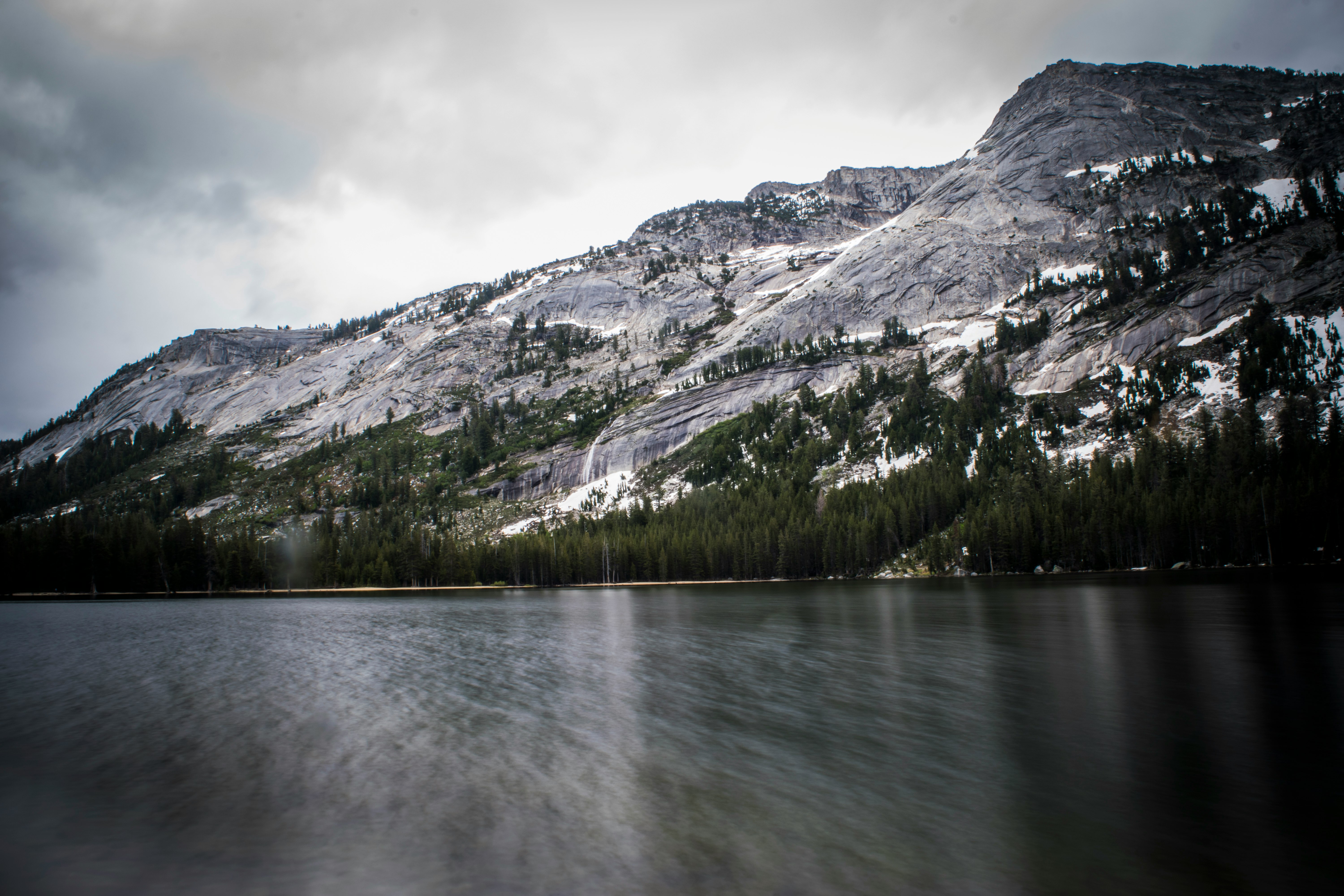 long exposure photo of body of water and mountains